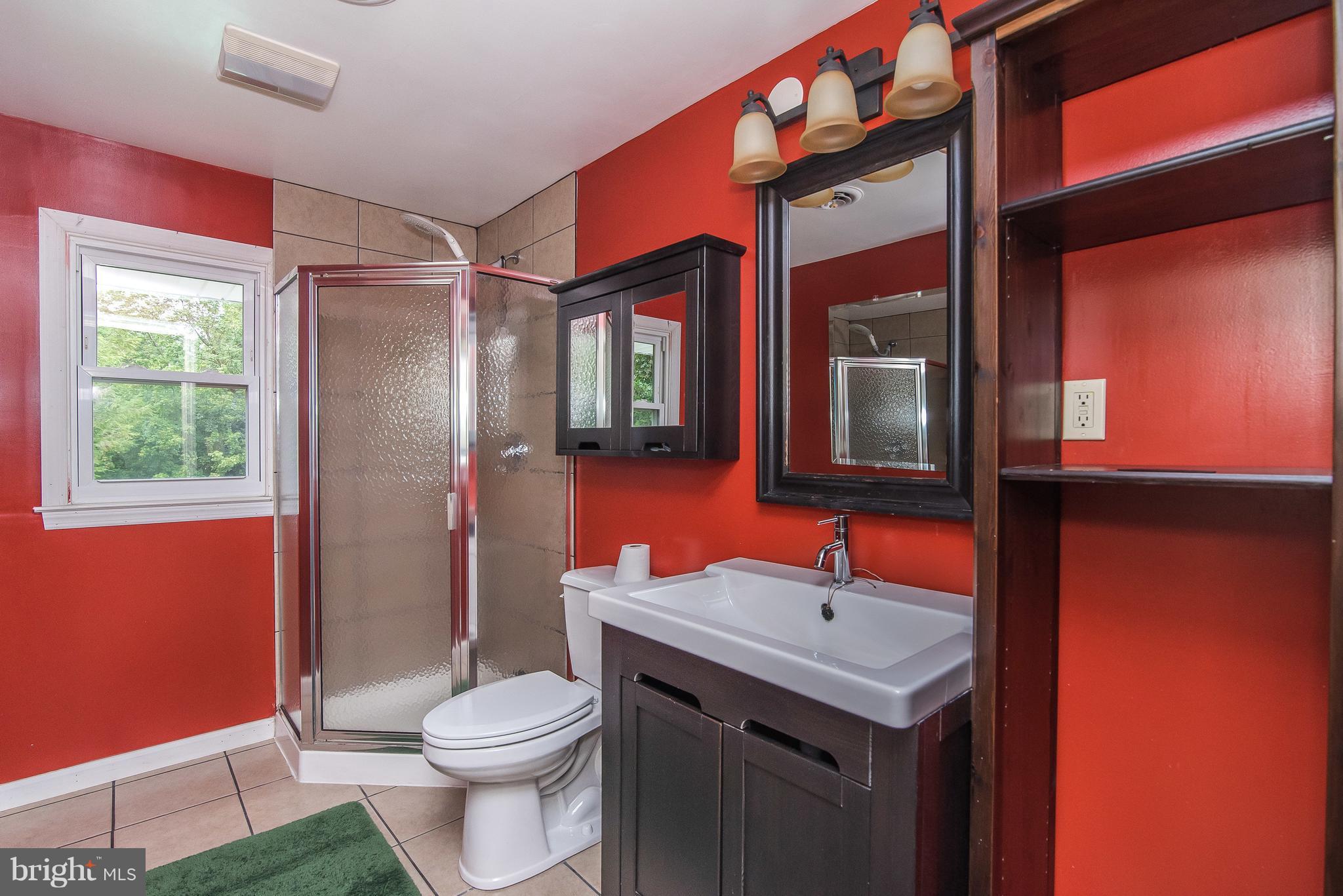 6116 Haddon Hall Road Baltimore, MD 21212 - Photo 27 of 44 a bathroom with a toilet sink and mirror