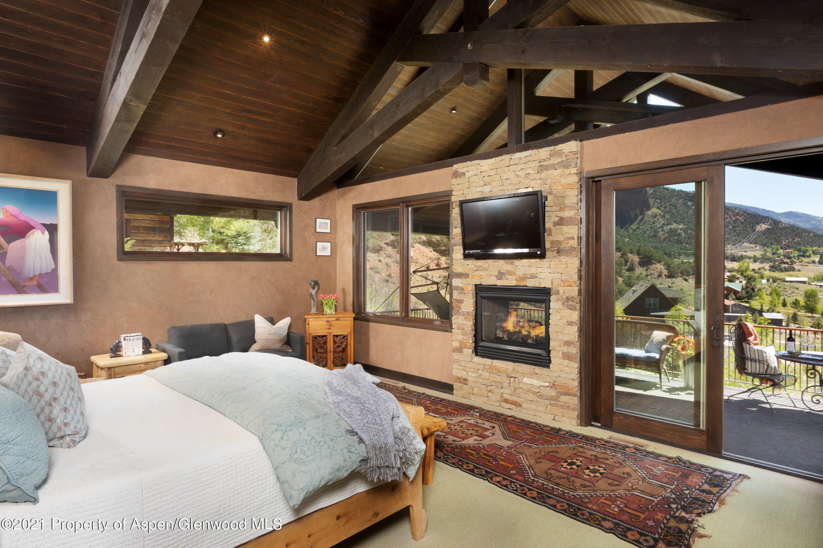 4559 Frying Pan Road Basalt, CO 81621 - Photo 15 of 35 a bedroom with a bed and a fireplace