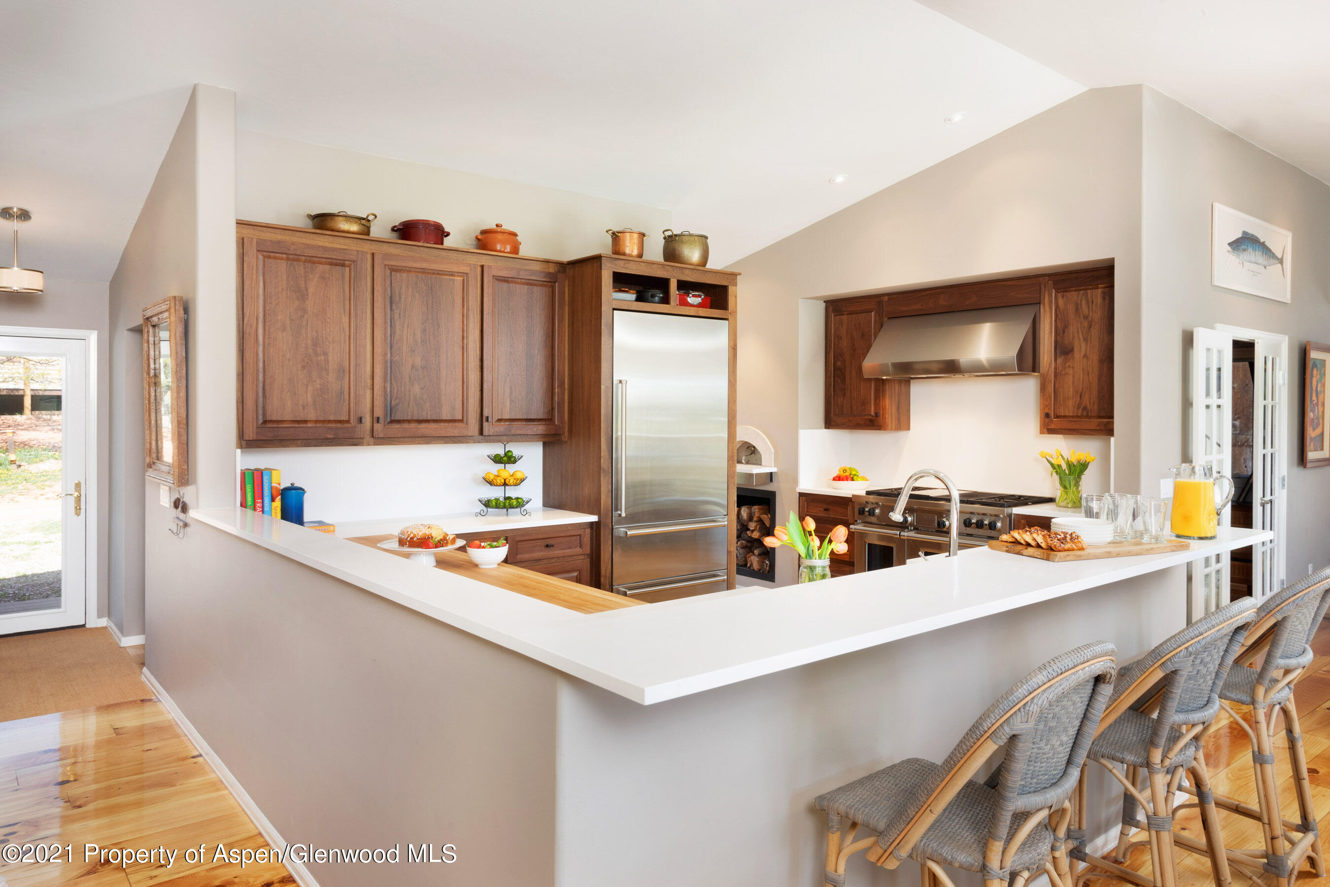 4559 Frying Pan Road Basalt, CO 81621 - Photo 5 of 35 a kitchen with stainless steel appliances kitchen island a large counter top space and wooden floor