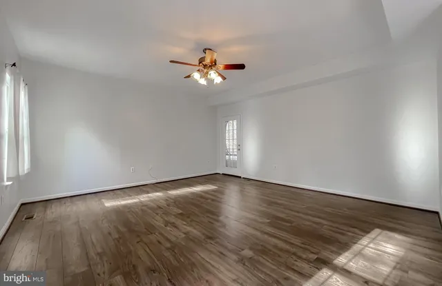a view of a livingroom with a ceiling fan and window