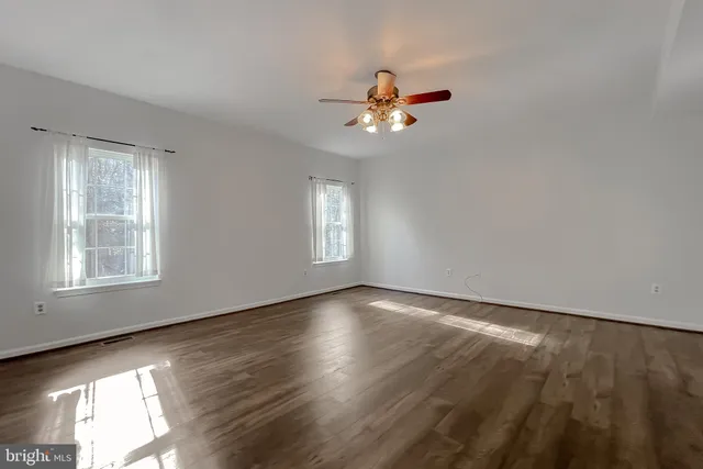 a spacious bathroom with a double vanity sink a toilet and a mirror
