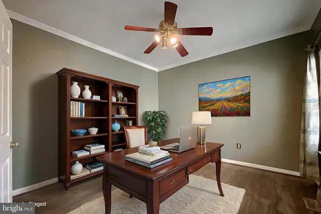an empty room with chandelier fan and windows