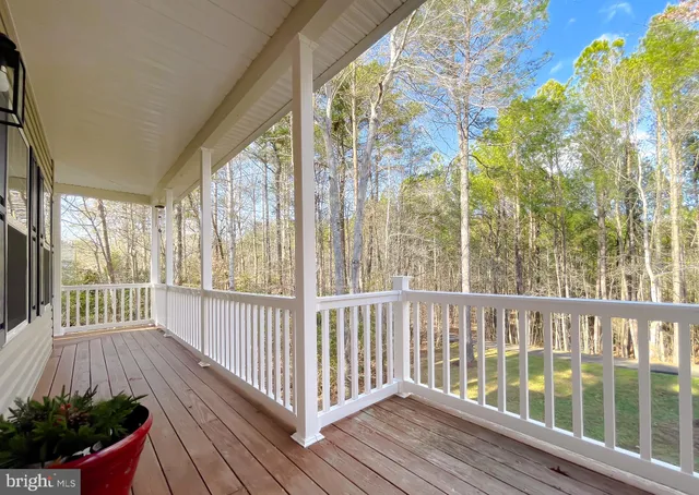 a view of a hallway with wooden floor and entryway