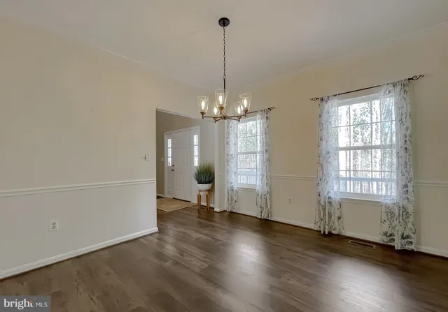 a living room with furniture a flat screen tv and a large window