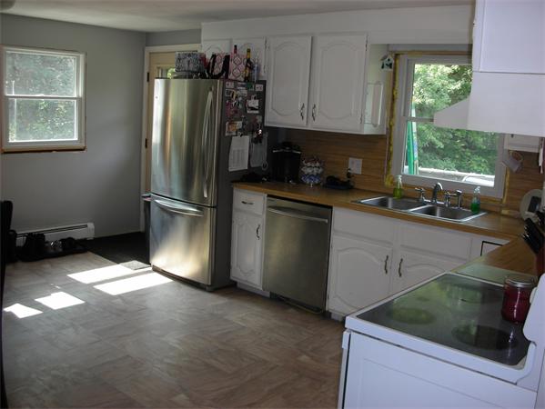95 Brookfield Road Charlton, MA 01507 - Photo 6 of 15 a kitchen with stainless steel appliances granite countertop a refrigerator sink and cabinets