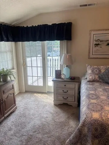 a view of bedroom with furniture and flat screen tv