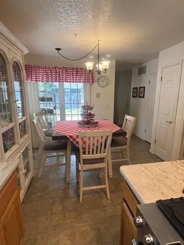 a dining room with furniture and window