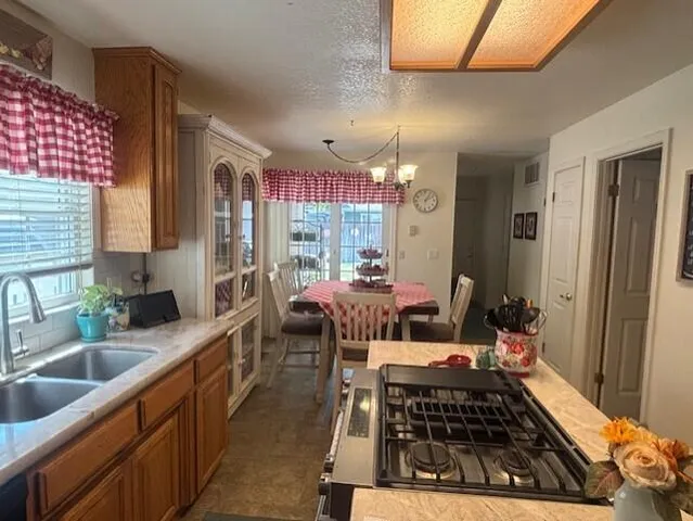 a large kitchen with a table and chairs