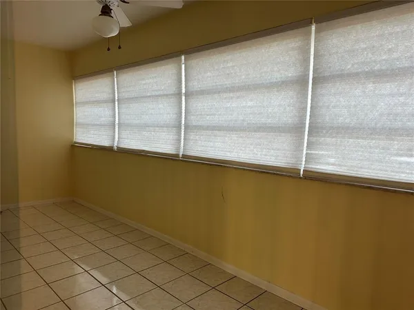 a view of a livingroom with an empty space and a ceiling fan