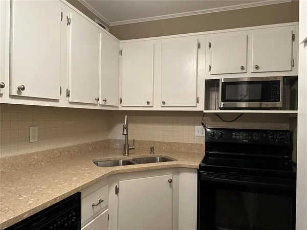 a kitchen with a refrigerator and a sink
