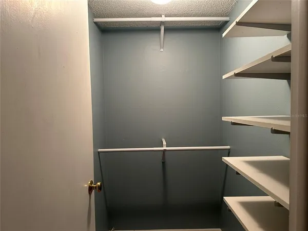 a bathroom with a granite countertop toilet sink mirror and vanity