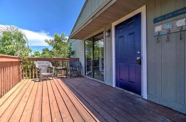 a view of balcony with wooden floor and outdoor seating