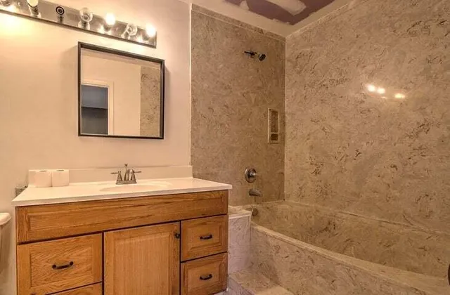 a bathroom with a sink a mirror and a bathtub