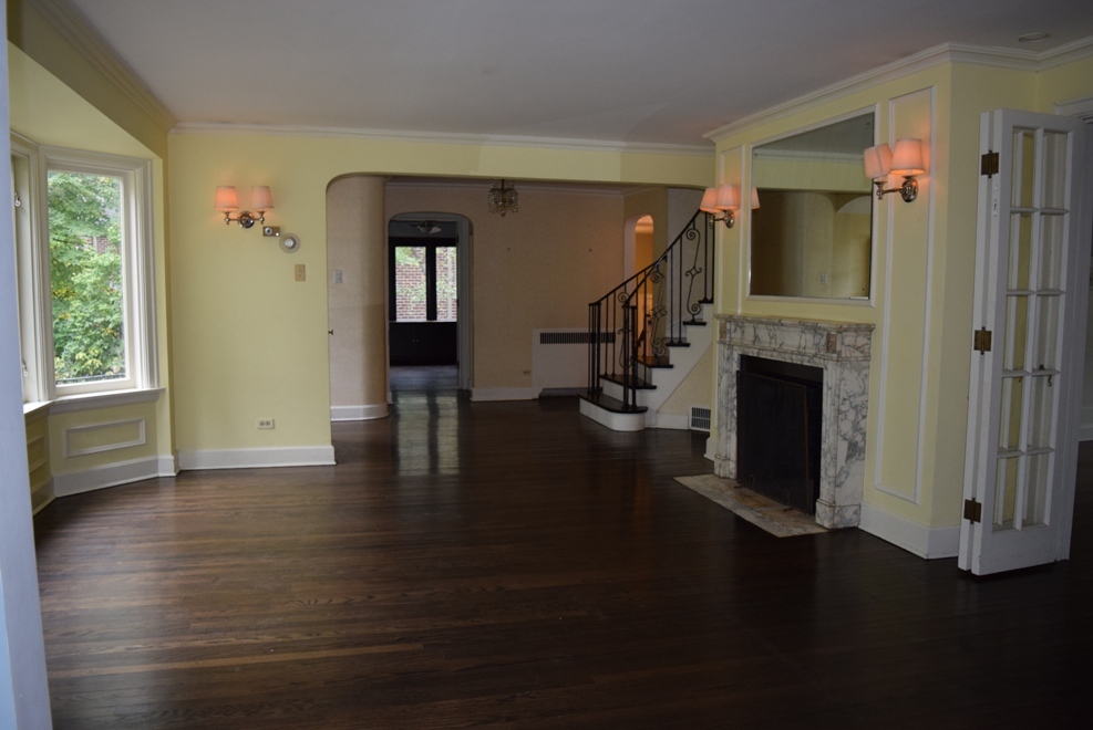 341 Scottswood Road Riverside, IL 60546 - Photo 15 of 46 a hallway with wooden floor fireplace and windows