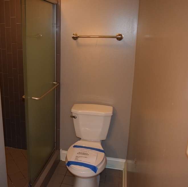 341 Scottswood Road Riverside, IL 60546 - Photo 31 of 46 a white toilet sitting in a bathroom next to a wooden wall