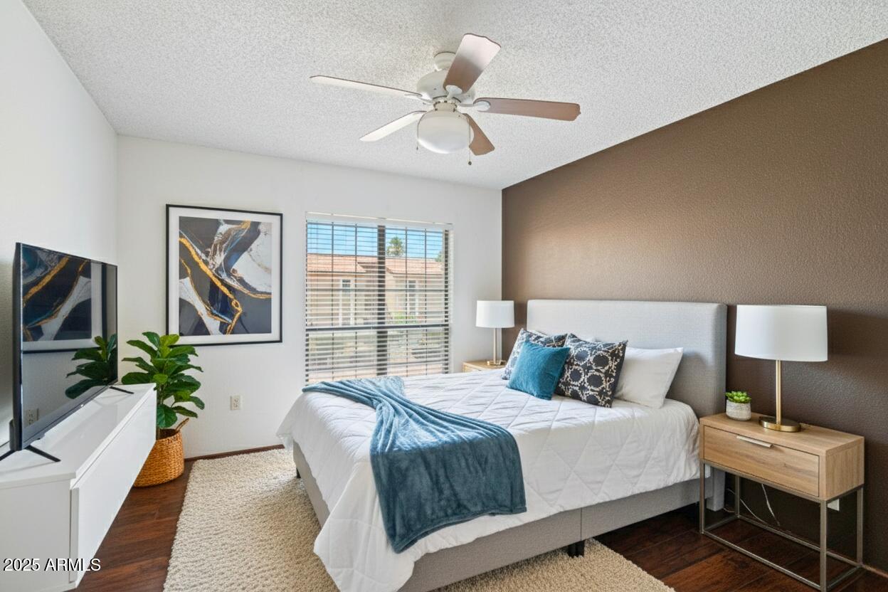 10410 North Cave Creek Road, Unit 2229 Phoenix, AZ 85020 - Photo 11 of 27 a bedroom with a bed and a chandelier