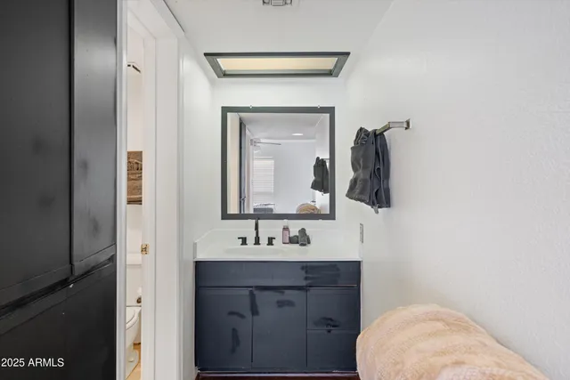 a bathroom with a sink vanity and mirror
