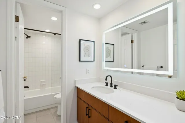 a bathroom with a tub sink and mirror