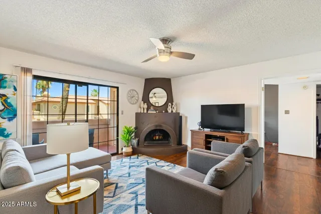 a living room with furniture a fireplace and a flat screen tv