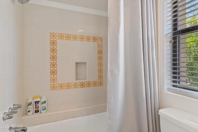 a bathroom with a bathtub and a window