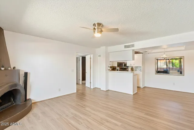 a view of a kitchen with wooden floor and a ceiling fan