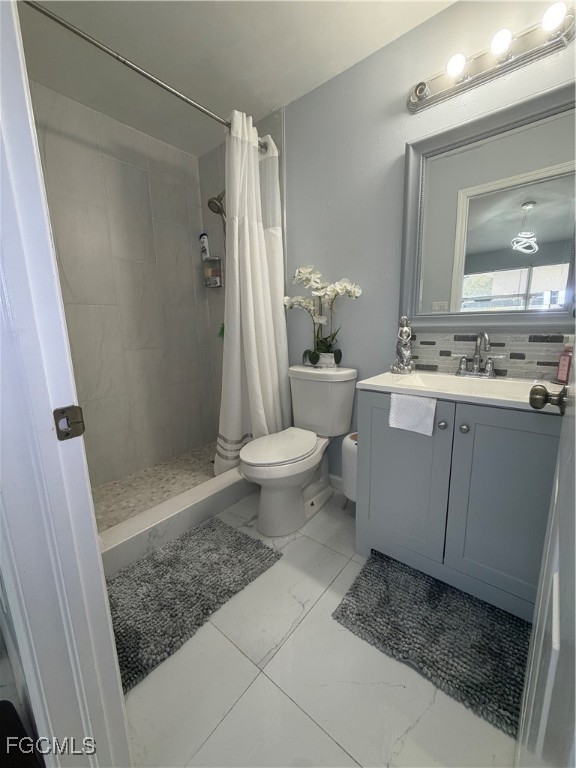 4427 25th Street Southwest Lehigh Acres, FL 33973 - Photo 11 of 20 a bathroom with a sink a toilet and shower