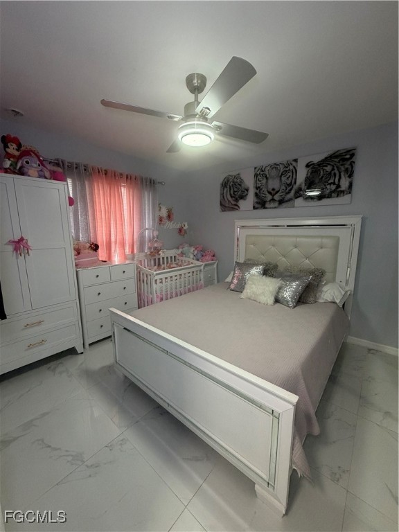 4427 25th Street Southwest Lehigh Acres, FL 33973 - Photo 12 of 20 a spacious bedroom with a bed and a chandelier
