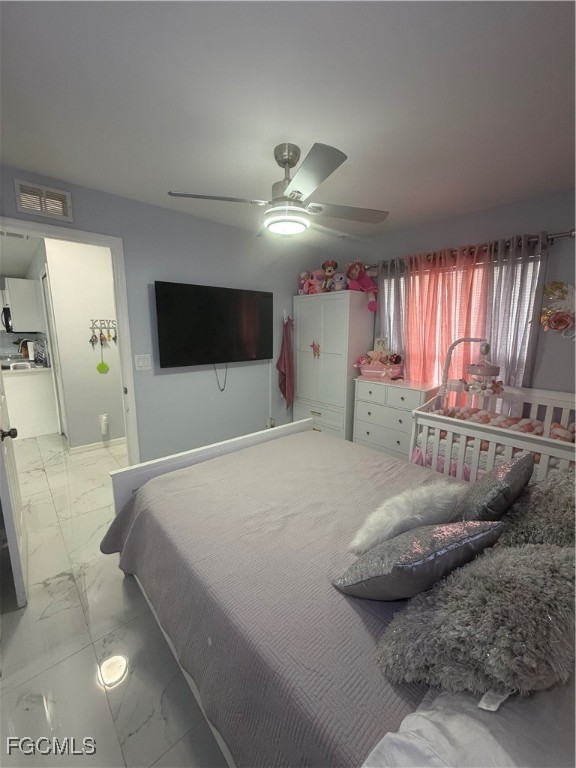 4427 25th Street Southwest Lehigh Acres, FL 33973 - Photo 13 of 20 a bedroom with a bed and a flat tv screen on dresser