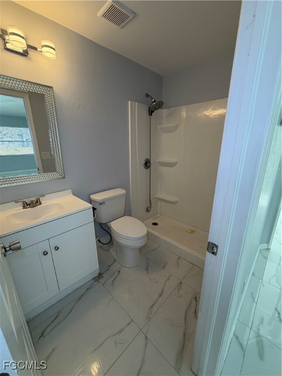 4427 25th Street Southwest Lehigh Acres, FL 33973 - Photo 6 of 20 a bathroom with a granite countertop sink toilet and shower