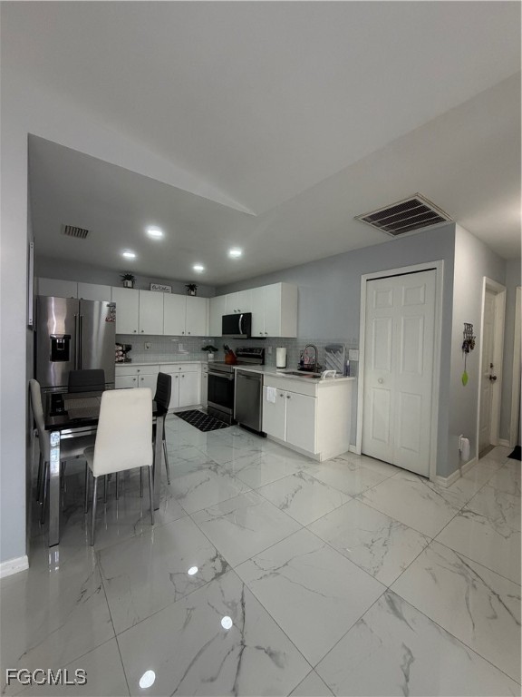 4427 25th Street Southwest Lehigh Acres, FL 33973 - Photo 8 of 20 a view of kitchen with stainless steel appliances kitchen island microwave and cabinets
