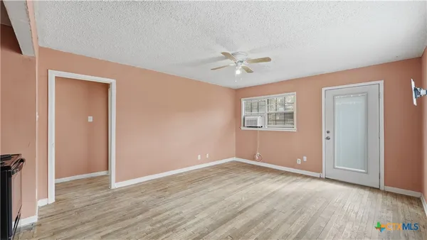 wooden floor in an empty room with a window