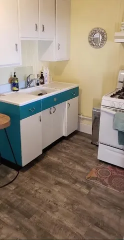 a kitchen with a cabinets and white appliances