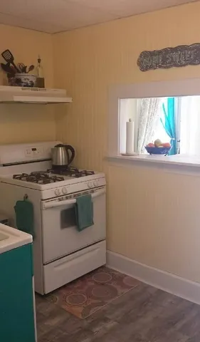 a stove top oven sitting inside of a kitchen