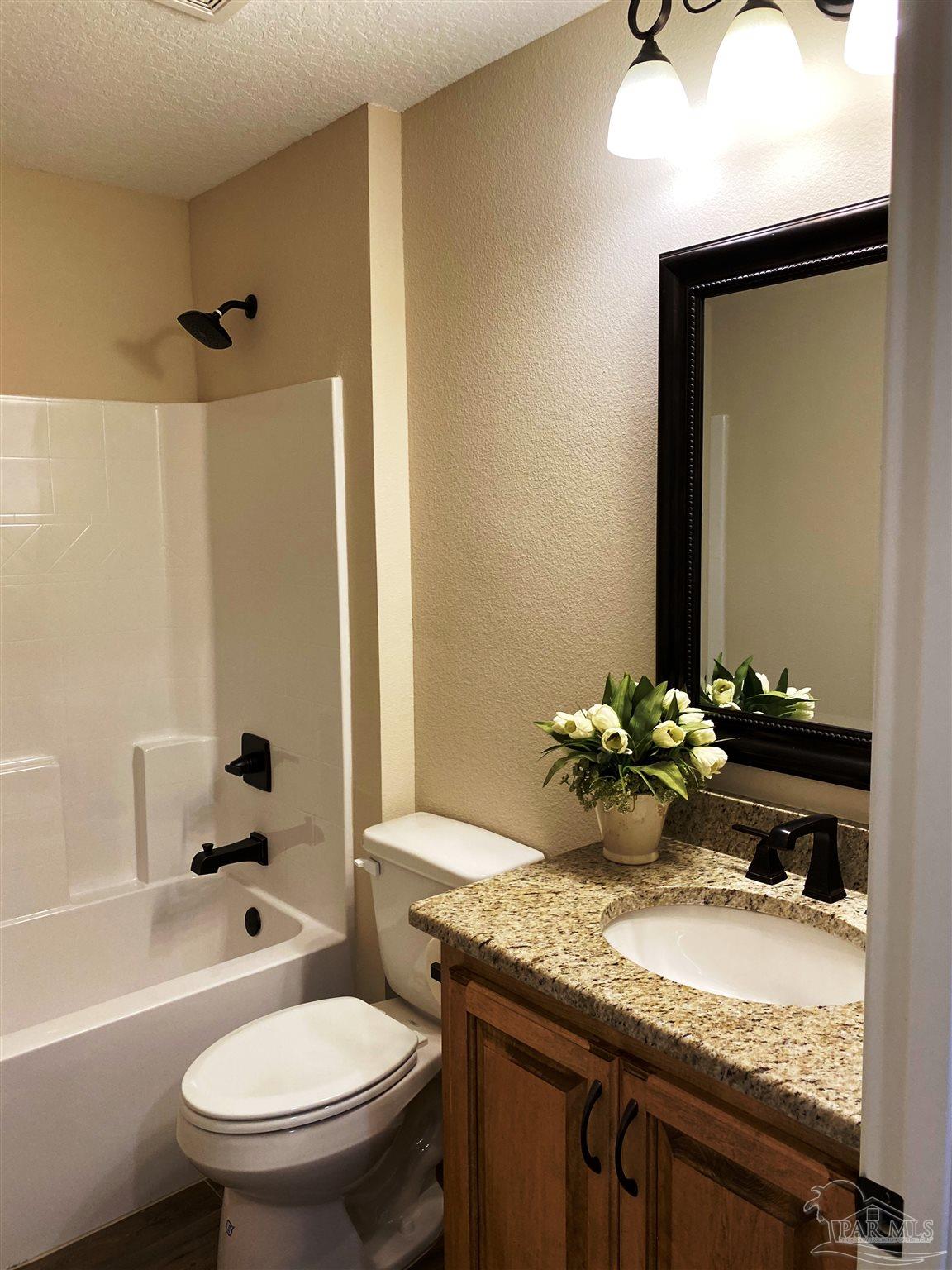 5472 South A Jones Road Milton, FL 32583 - Photo 21 of 29 A 2nd full bath has a shower/tub combination.