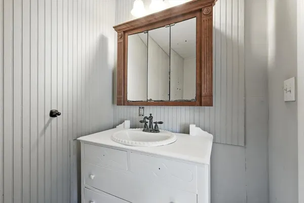 a bathroom with a sink and a mirror