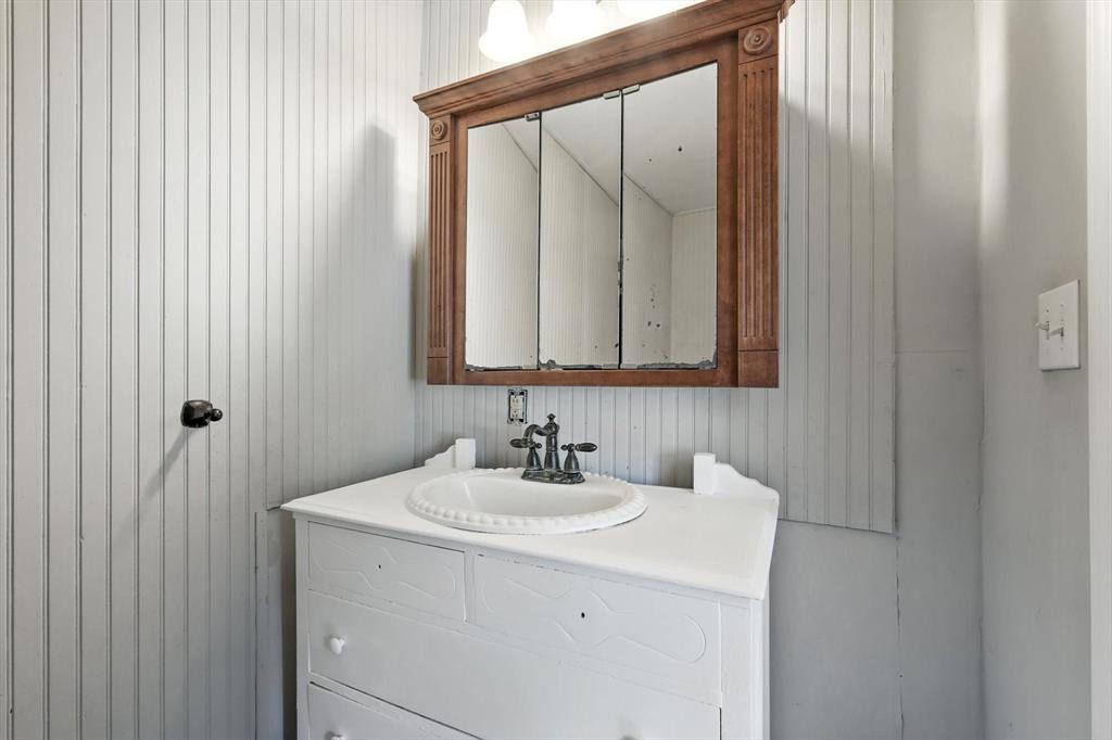400 Katy Street Alba, TX 75410 - Photo 26 of 40 a bathroom with a sink and a mirror