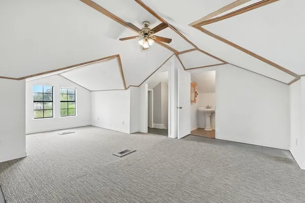 a view of a big room with wooden floor and windows