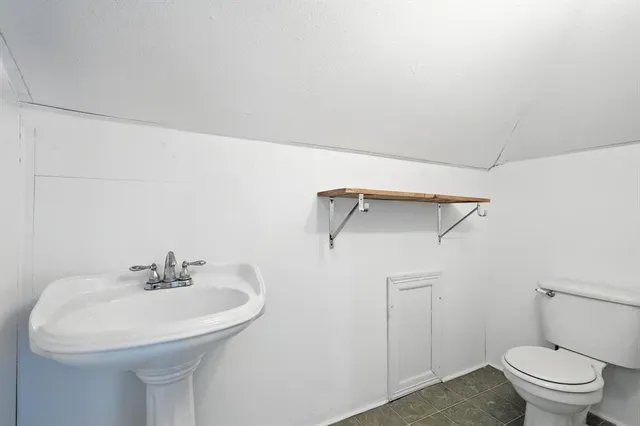 a bathroom with a sink a toilet and a mirror