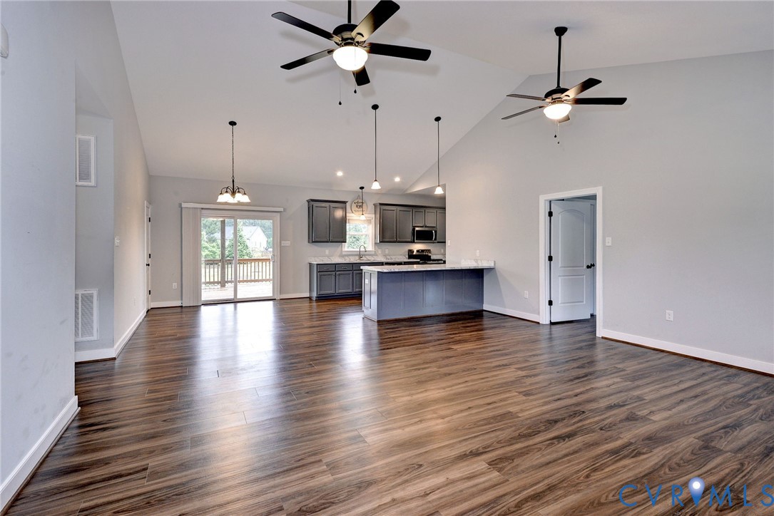 8904 Rock Cedar Road New Kent, VA 23124 - Photo 3 of 37 a view of a room with wooden floor and a kitchen