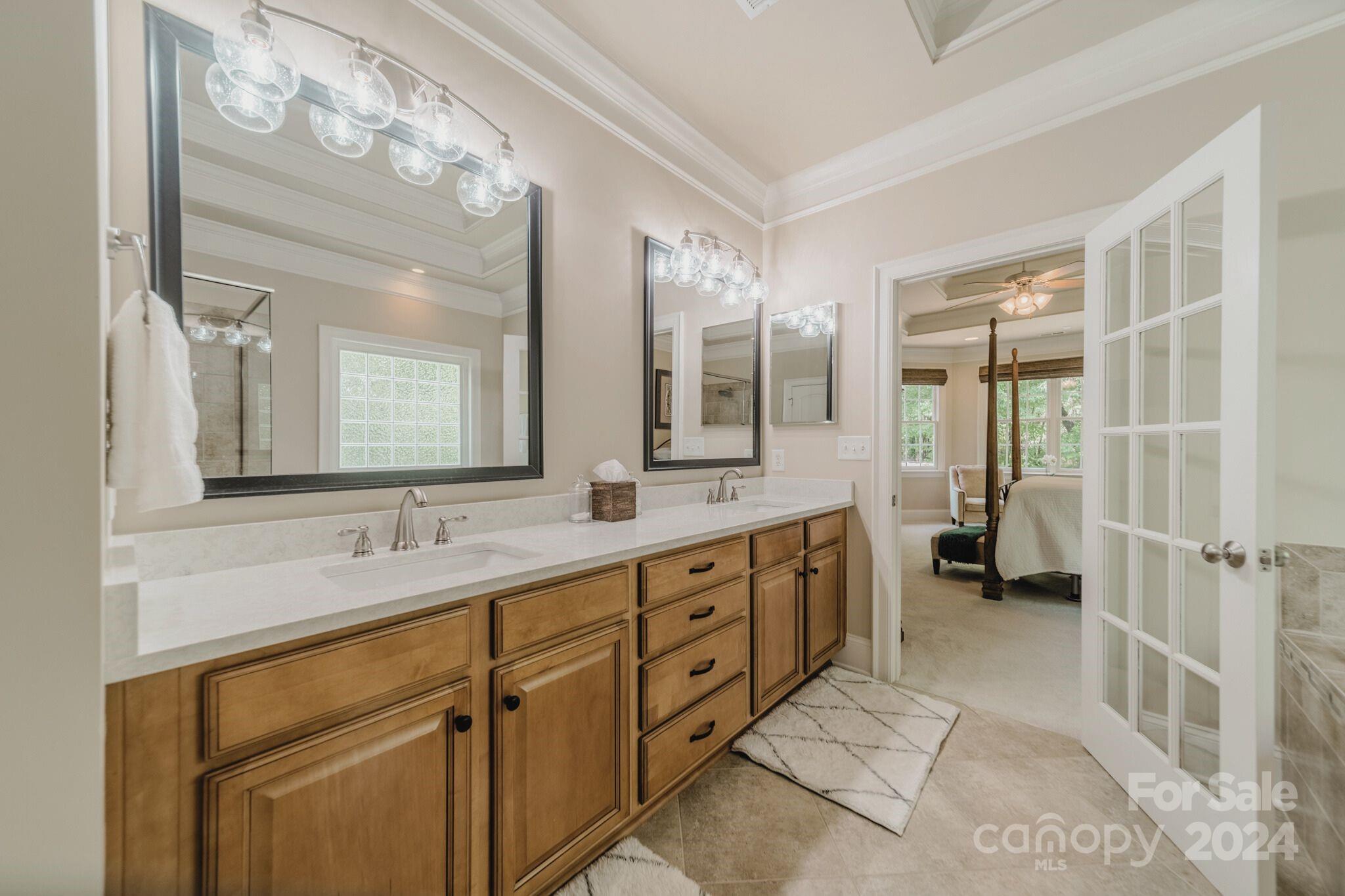 4273 Sailview Drive Denver, NC 28037 - Photo 11 of 39 a spacious bathroom with double vanity a mirror and a shower