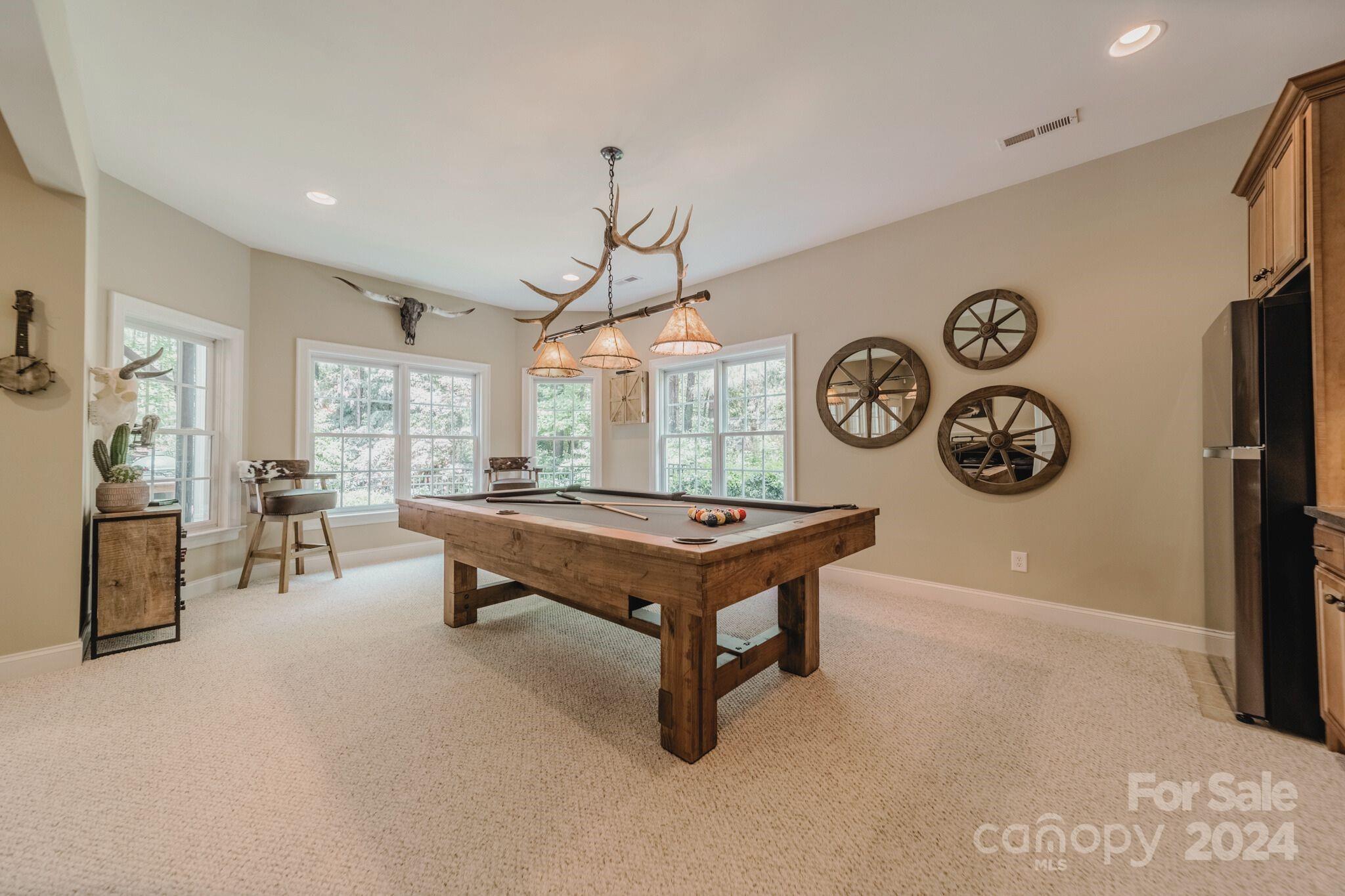 4273 Sailview Drive Denver, NC 28037 - Photo 13 of 39 a living room with a table and a clock