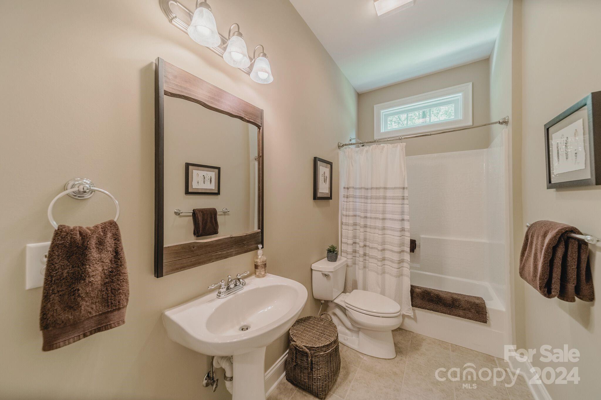 4273 Sailview Drive Denver, NC 28037 - Photo 21 of 39 a bathroom with a toilet a sink and mirror