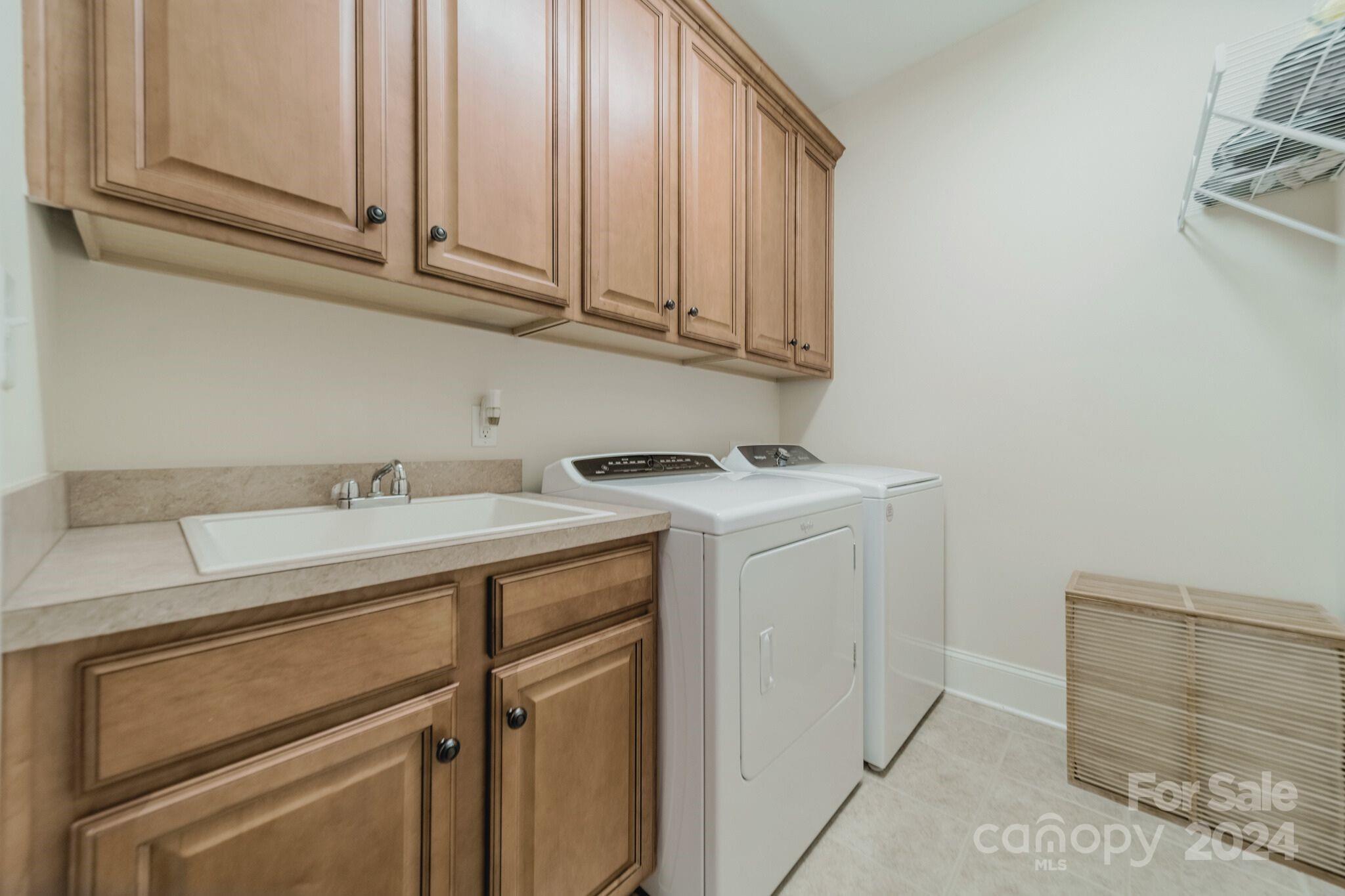 4273 Sailview Drive Denver, NC 28037 - Photo 23 of 39 a utility room with granite countertop cabinets washer and dryer