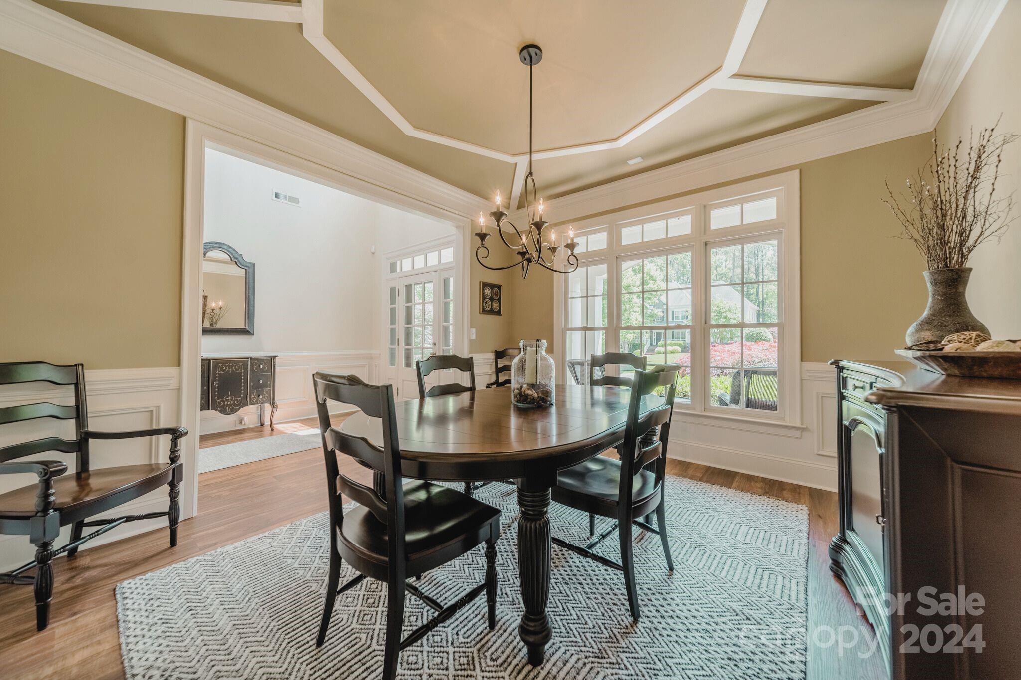 4273 Sailview Drive Denver, NC 28037 - Photo 9 of 39 a dining room with furniture a chandelier and wooden floor