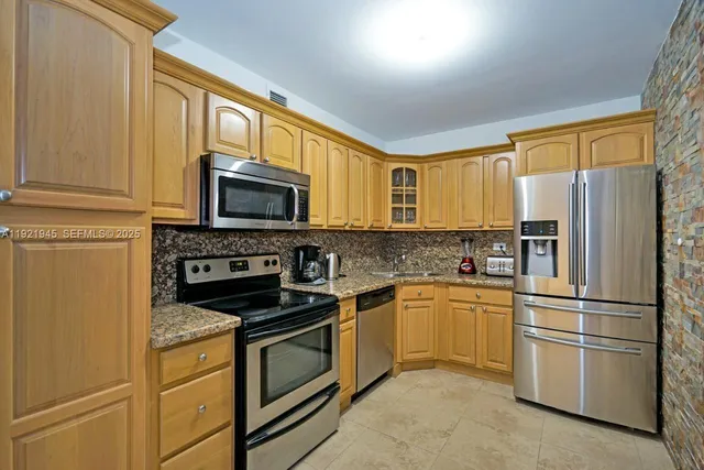 a kitchen with a refrigerator stove and microwave