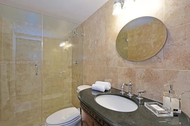 a bathroom with a sink toilet and mirror