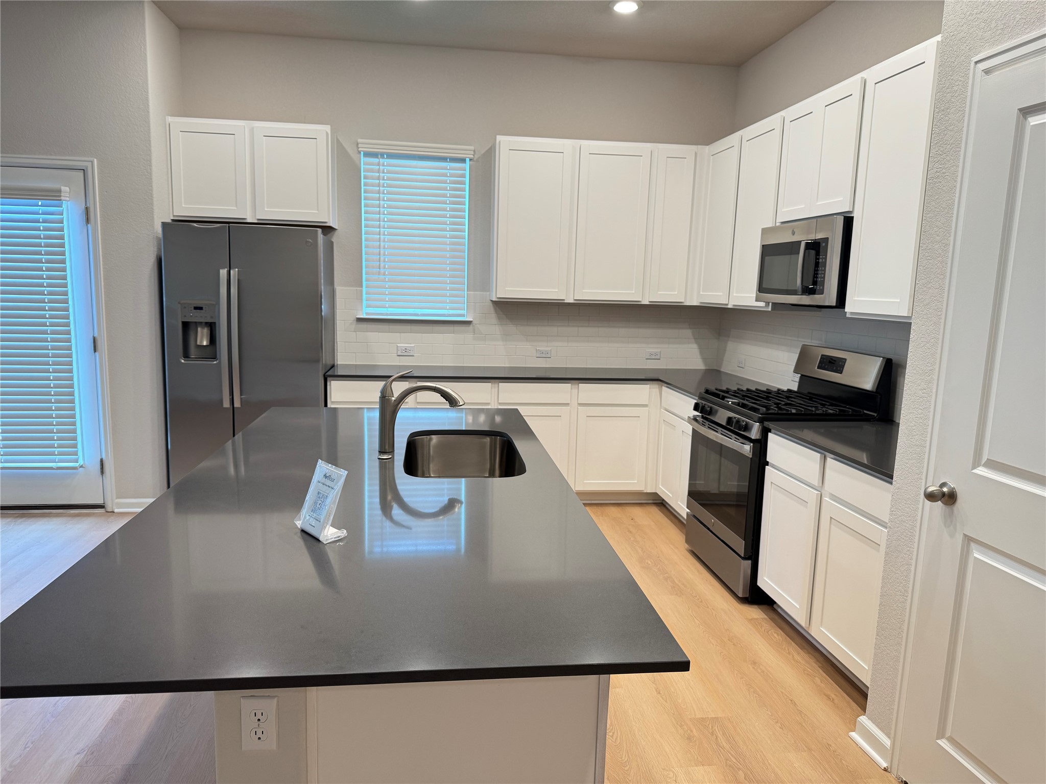3000 Chisholm Trail Road, Unit 3 Round Rock, TX 78681 - Photo 3 of 28 a kitchen with stainless steel appliances granite countertop a sink a stove top oven a counter space and cabinets
