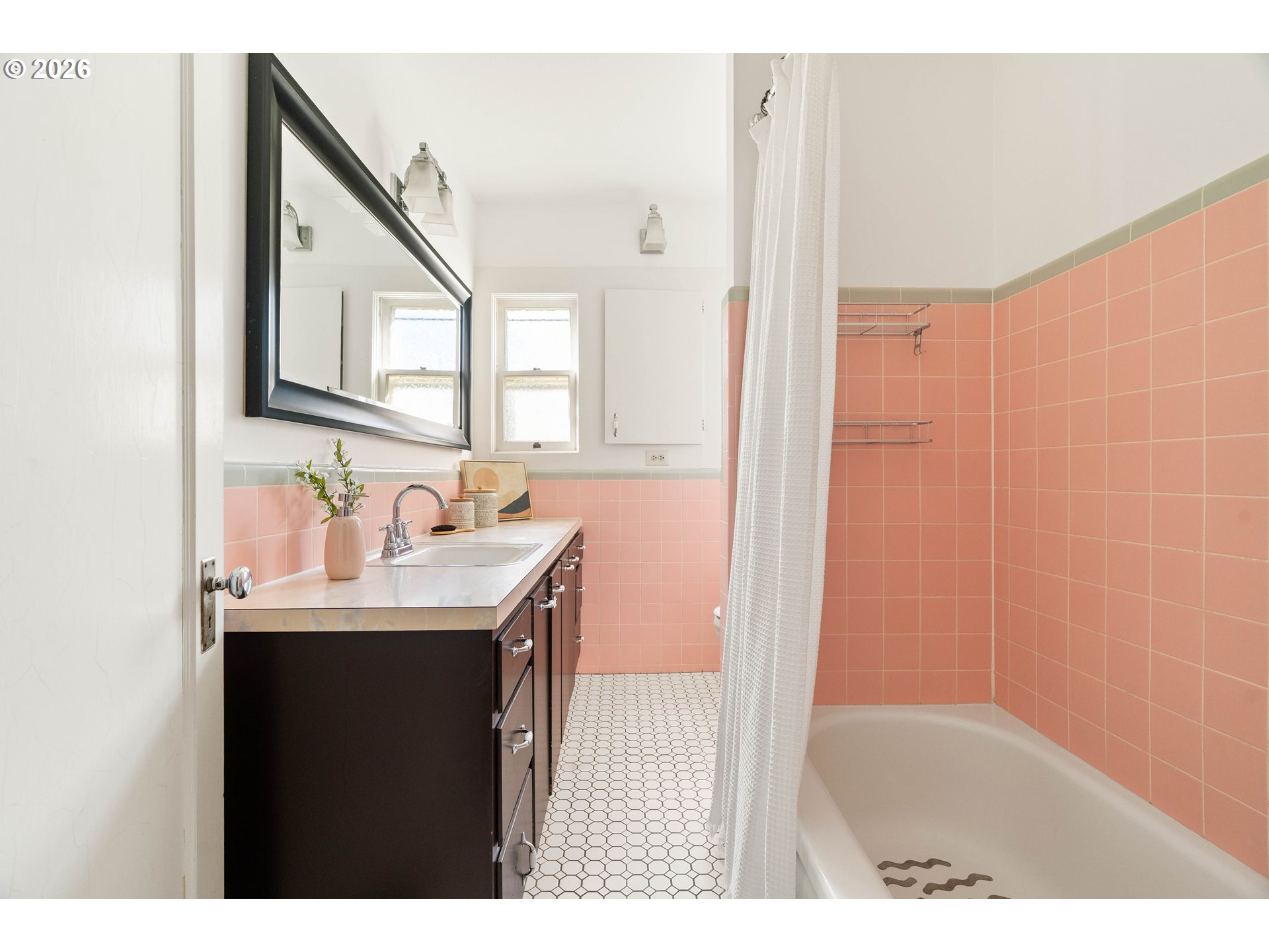 3215 Northeast 63rd Avenue Portland, OR 97213 - Photo 19 of 47 a bathroom with a sink a mirror and a shower