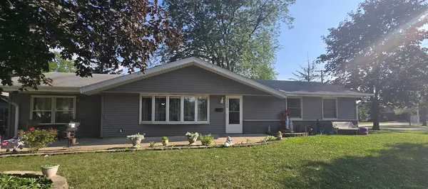 a front view of house with yard slide and outdoor seating