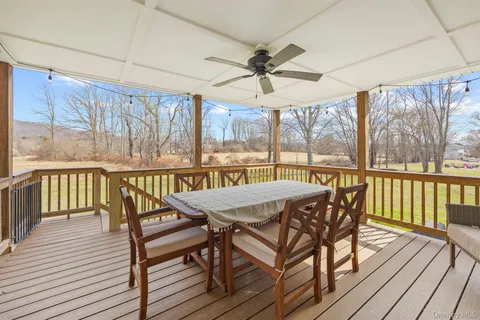 a view of a balcony with furniture and wooden floor
